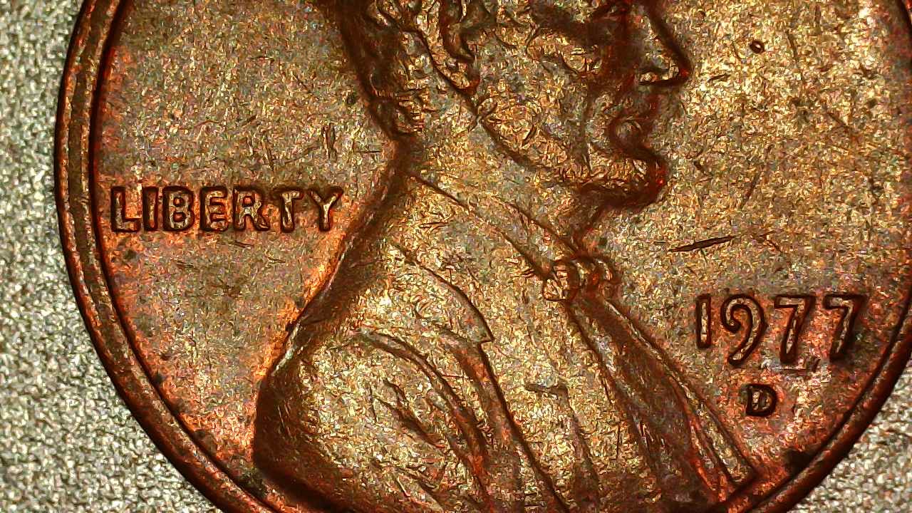 Side-by-side comparison of normal 1977-D penny versus DDO-001 doubled die obverse showing doubling on LIBERTY