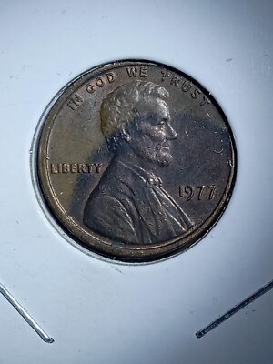 1977 Lincoln penny off-center strike error showing crescent-shaped blank area and full visible date